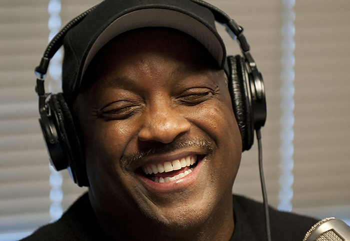 Donnie Simpson smiling wearing headphones in studio